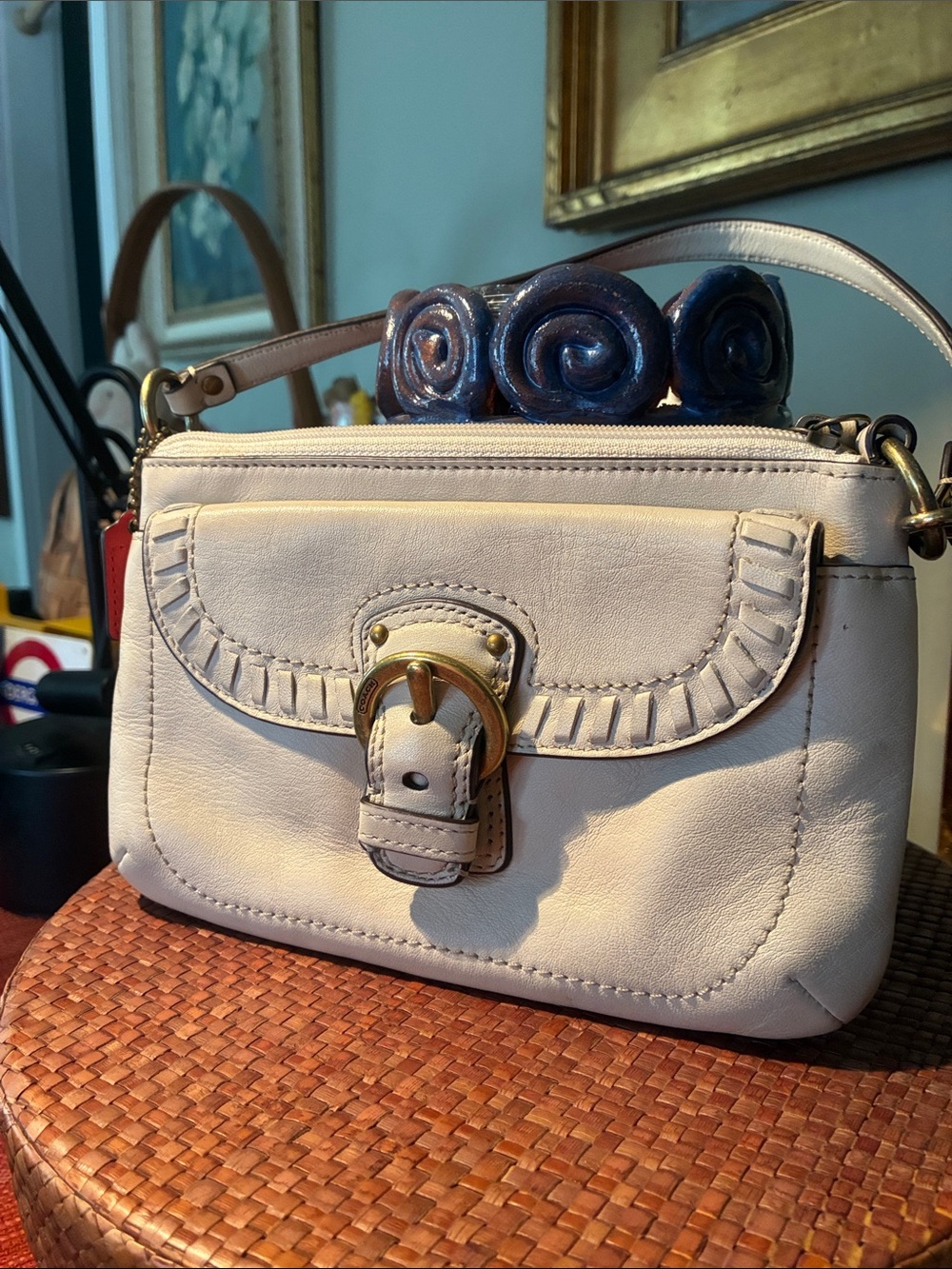 Coach Ivory Shoulder bag with charming whipstitch trim and a front Brass Buckle